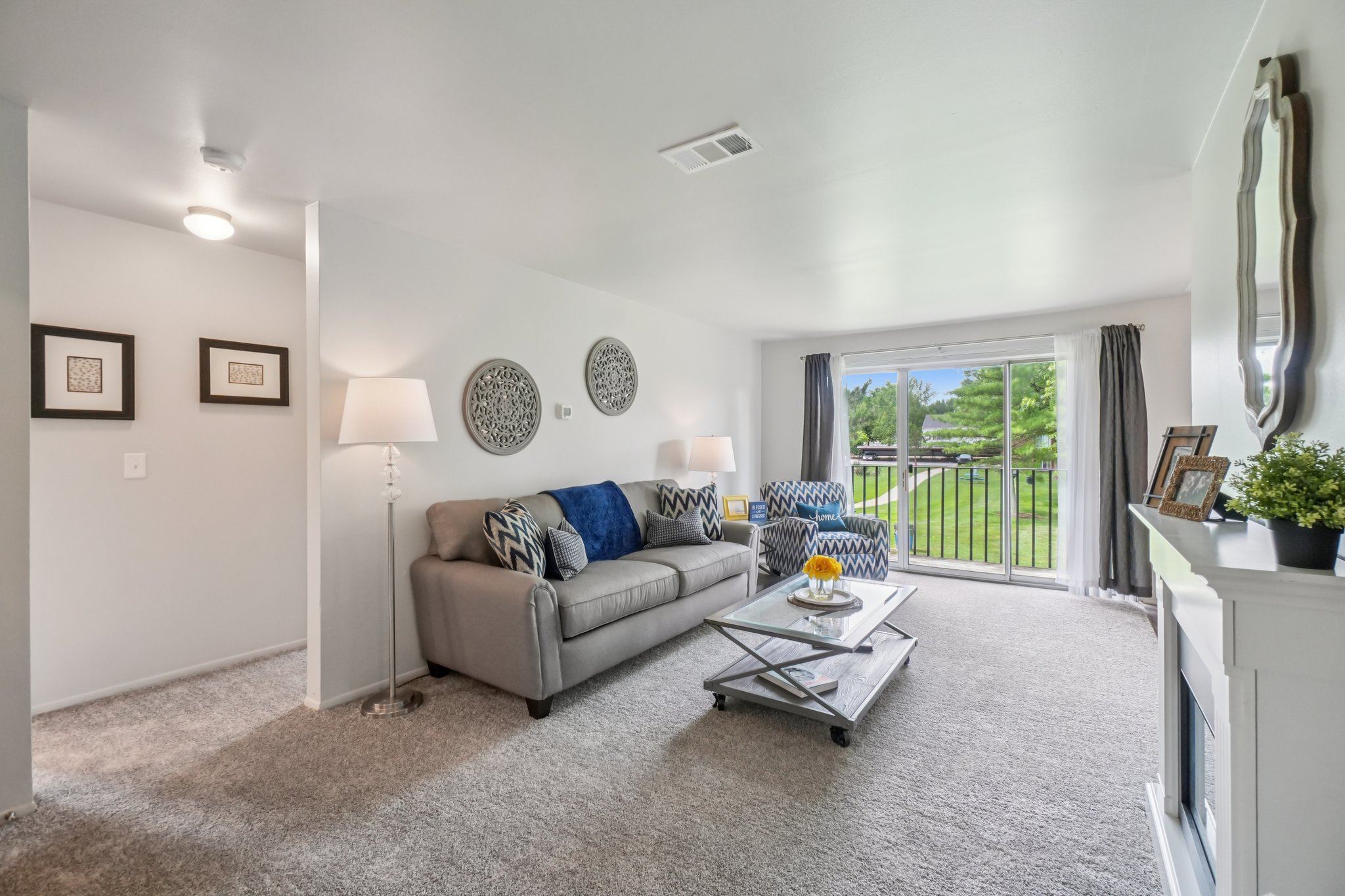 Elevated living room and private patio or balcony at Drawbridge Apartments in Harrison Township, MI.