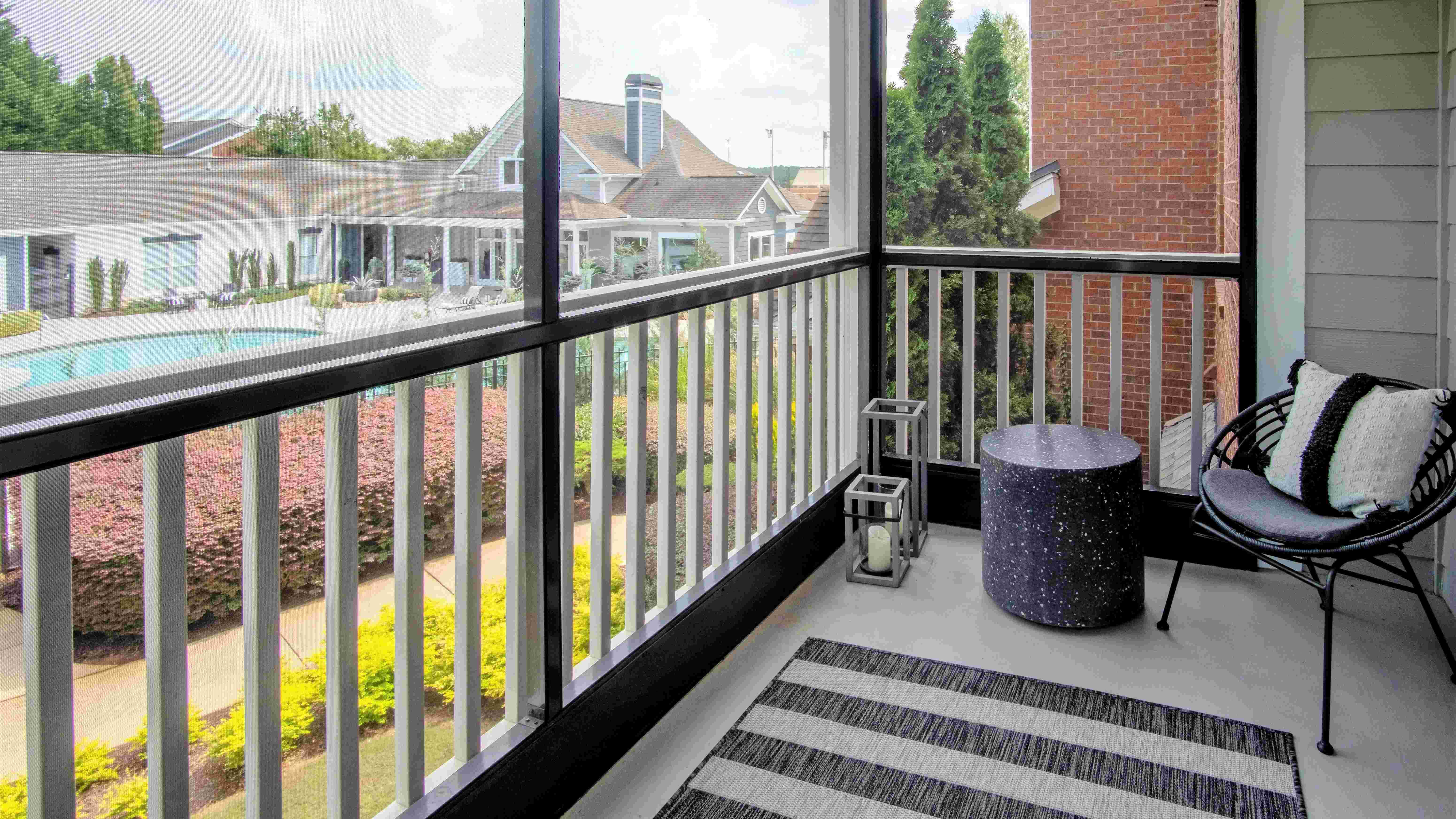 Embrace the fresh air and cozy comfort with our serene screened-in patios. (In select units)