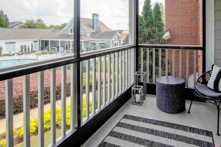 Embrace the fresh air and cozy comfort with our serene screened-in patios. (In select units)