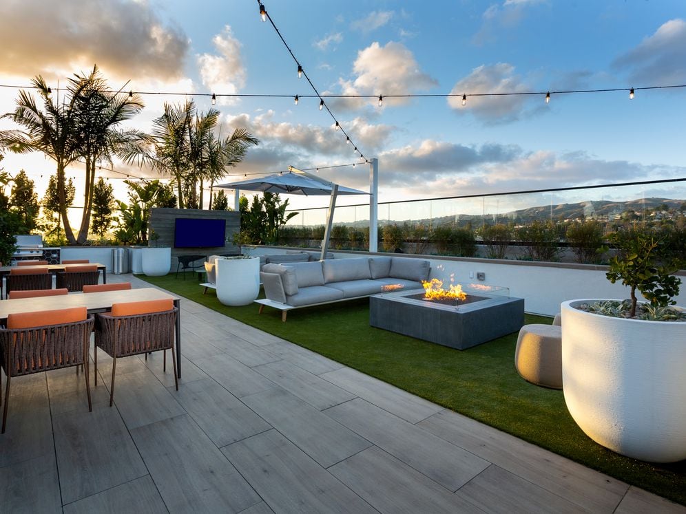 Building B rooftop lounge with fireplace and lounge seating