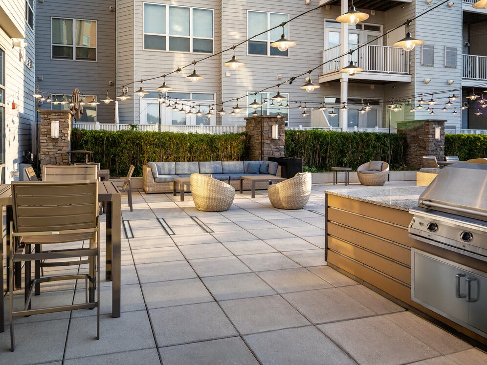 Rooftop patio with BBQ grills and lounge seating