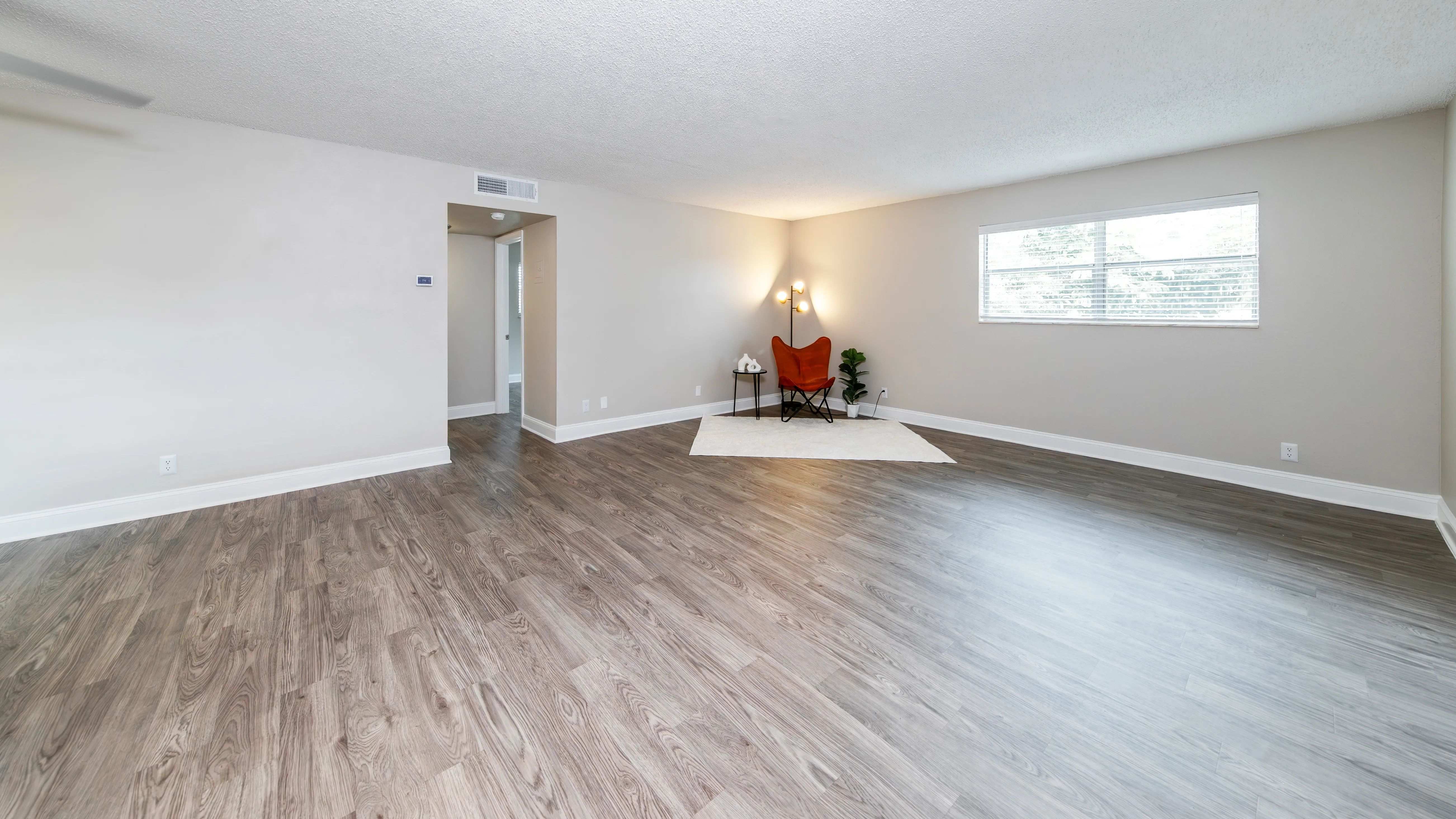 Feel pure comfort in your spacious living room, where your warm, wood-style flooring adds to the enjoyment of living at Boca Winds. 