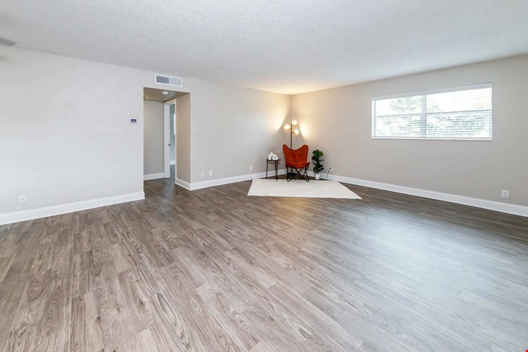 Feel pure comfort in your spacious living room, where your warm, wood-style flooring adds to the enjoyment of living at Boca Winds.