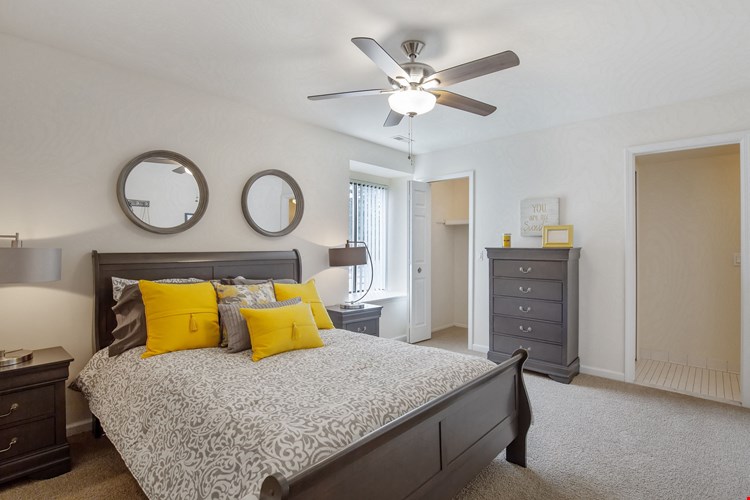 Master bedroom adjoining bathroom at Lakeside Village Apartments Clinton Township MI