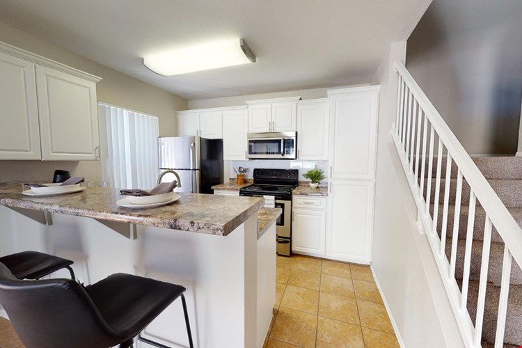 Our remodeled kitchens feature subway tile backsplashes, granite-style counter tops and stainless steel appliances.