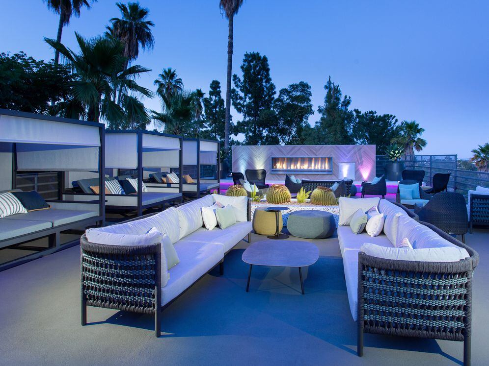 Outdoor lounge with cabanas and fireplace