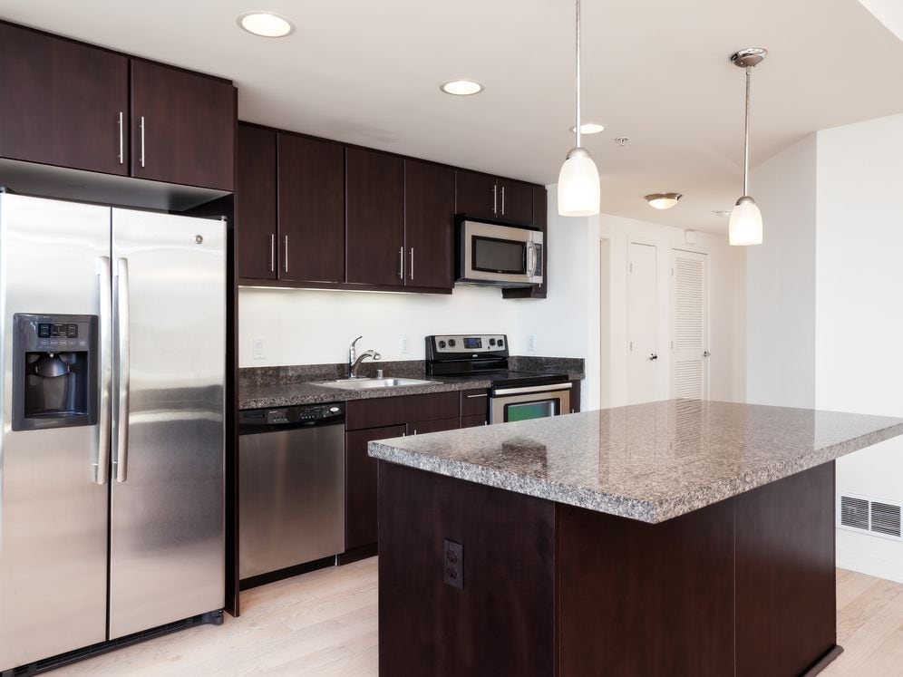 Classic Phase III kitchen with granite countertops, espresso cabinetry, and hard surface flooring