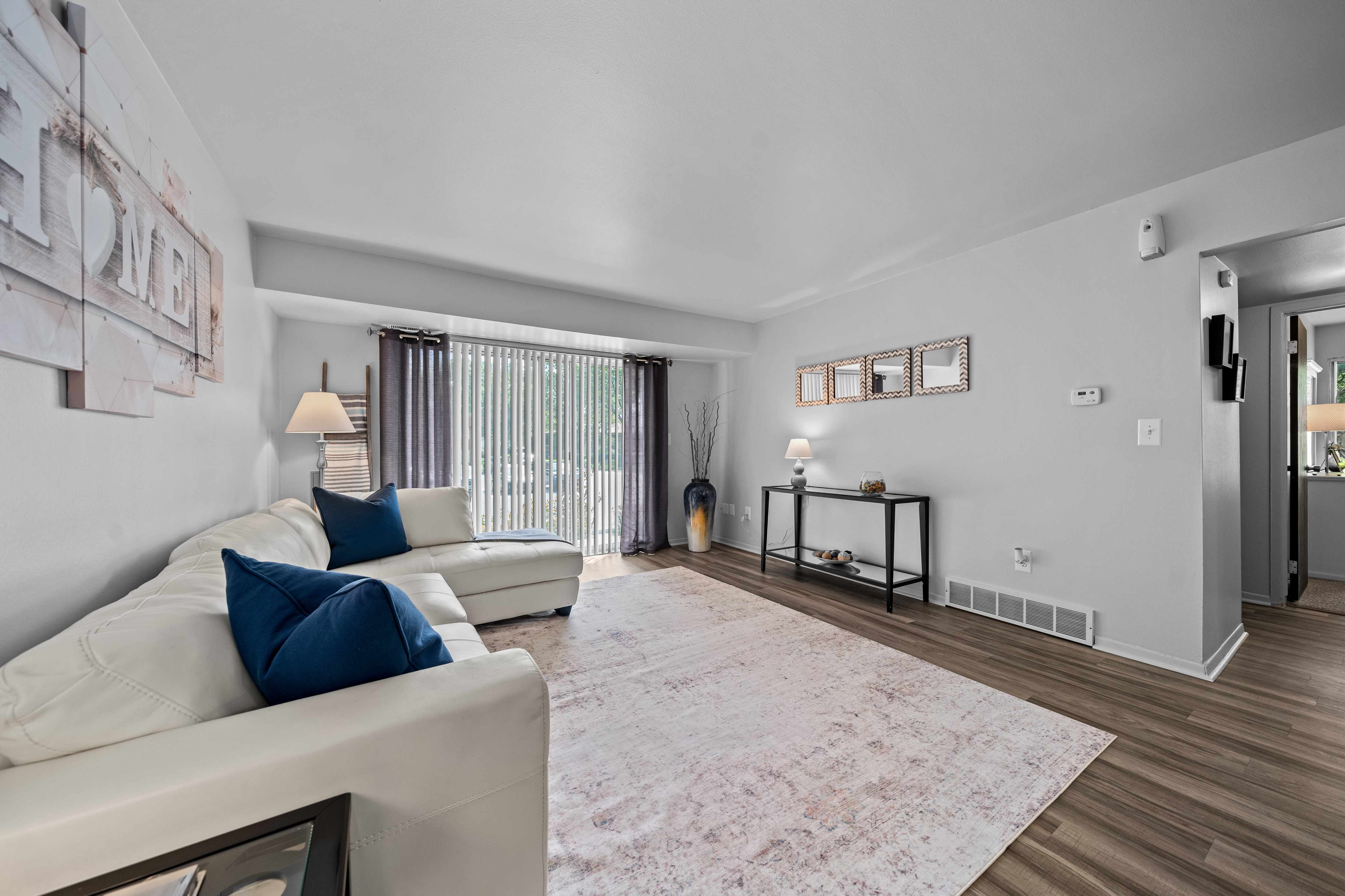 Spacious living room with natural light at Westwood Village Apartments in Westland, MI