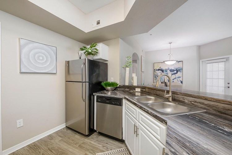Your newly remodeled kitchen includes ample cabinet space and your very own laundry room.