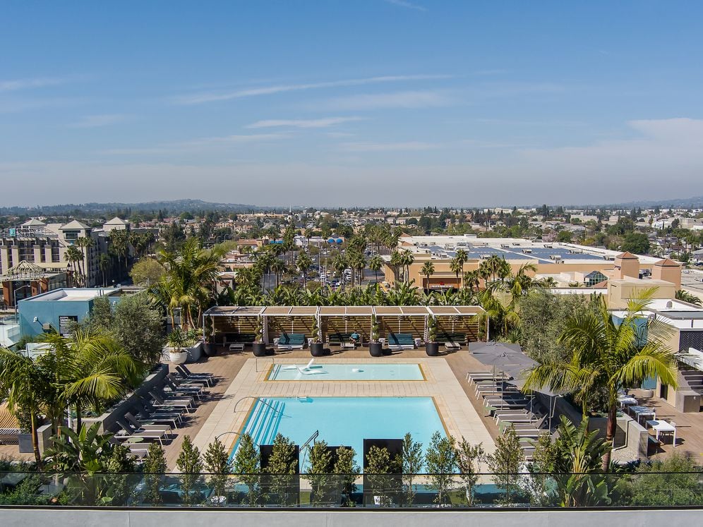 Building A rooftop pool with lounge seating and cabanas
