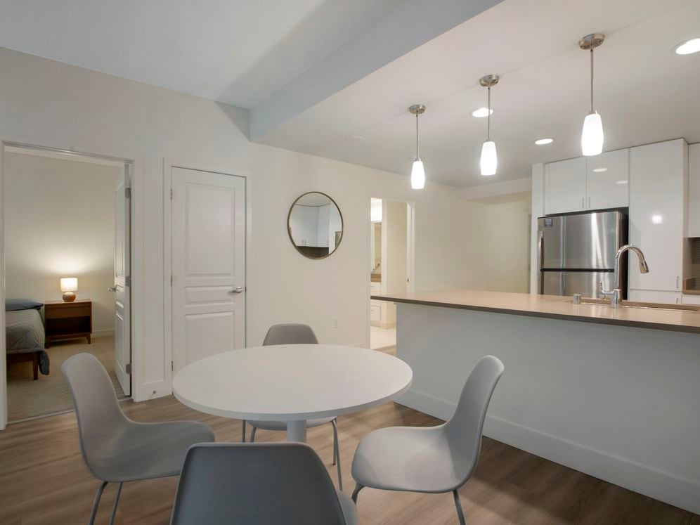 Furnished+ apartment homes include a dining set (Representative Image – exact items and style of furnishings may vary)