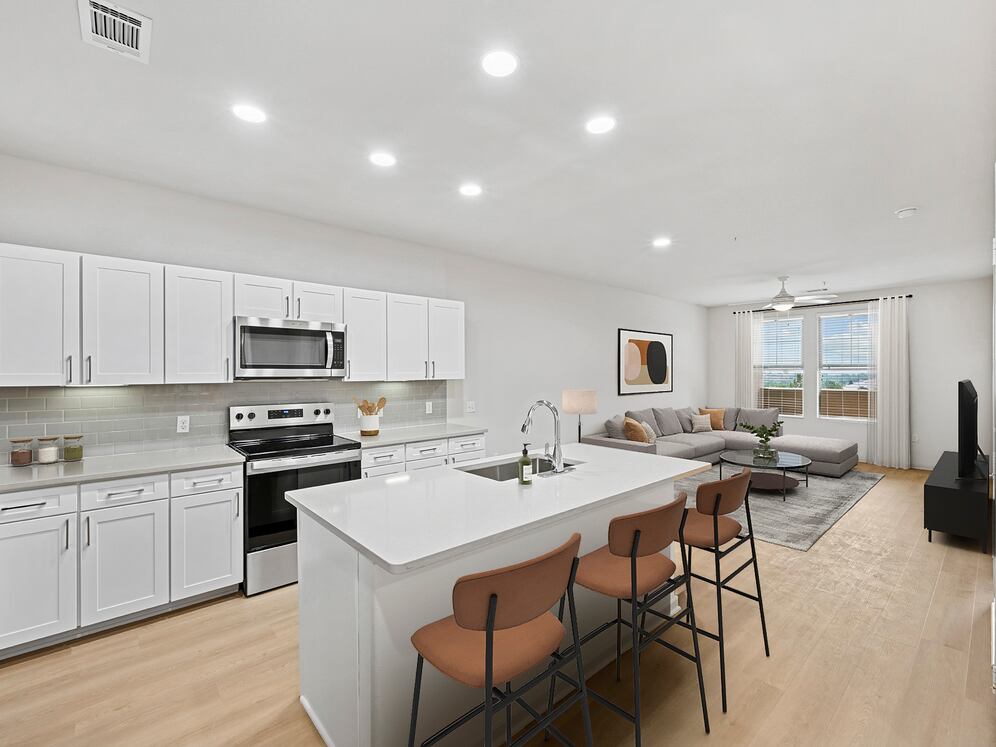 Renovated Package I kitchen with white cabinetry, grey quartz countertops, grey subway tile backsplash, stainless steel appliances, and hard surface flooring
