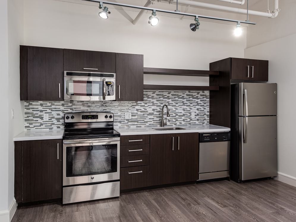 Loft Building kitchen with stainless steel appliances and backsplash