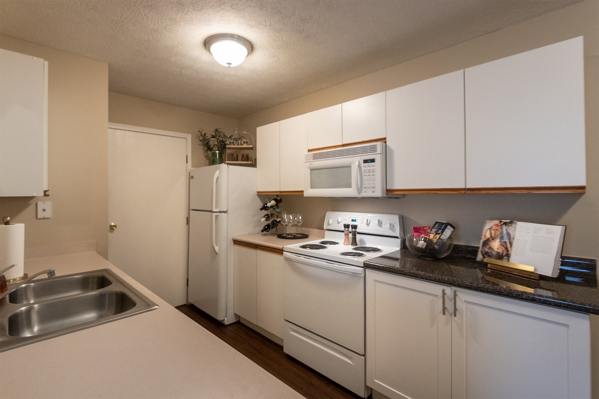 Our model Liberty kitchen features both upgraded cabinetry with dark countertops and classic cabinetry with light countertops.