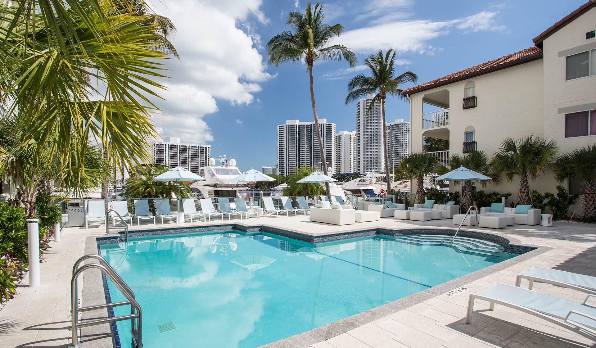 Outdoor, saltwater pool and sundeck overlooks the marina and views of the city