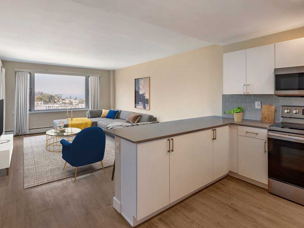 Limited availability: newly renovated Finish Package II apartment homes featuring kitchens with grey quartz countertops, white cabinetry, stainless steel appliances, grey tile backsplash, and hard surface flooring