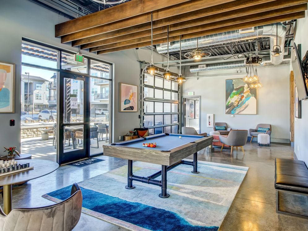 Resident's clubhouse with entertaining kitchenette, flat-screen television, billiards, and more