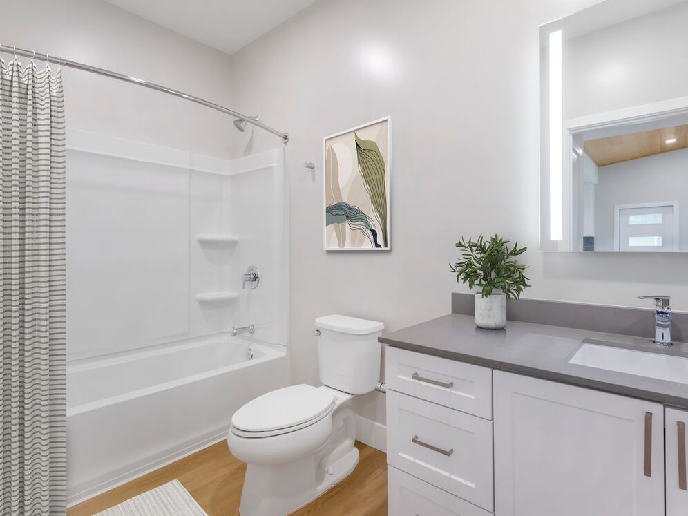 Freestanding Home bath with white cabinetry, grey quartz countertops, and hard surface flooring