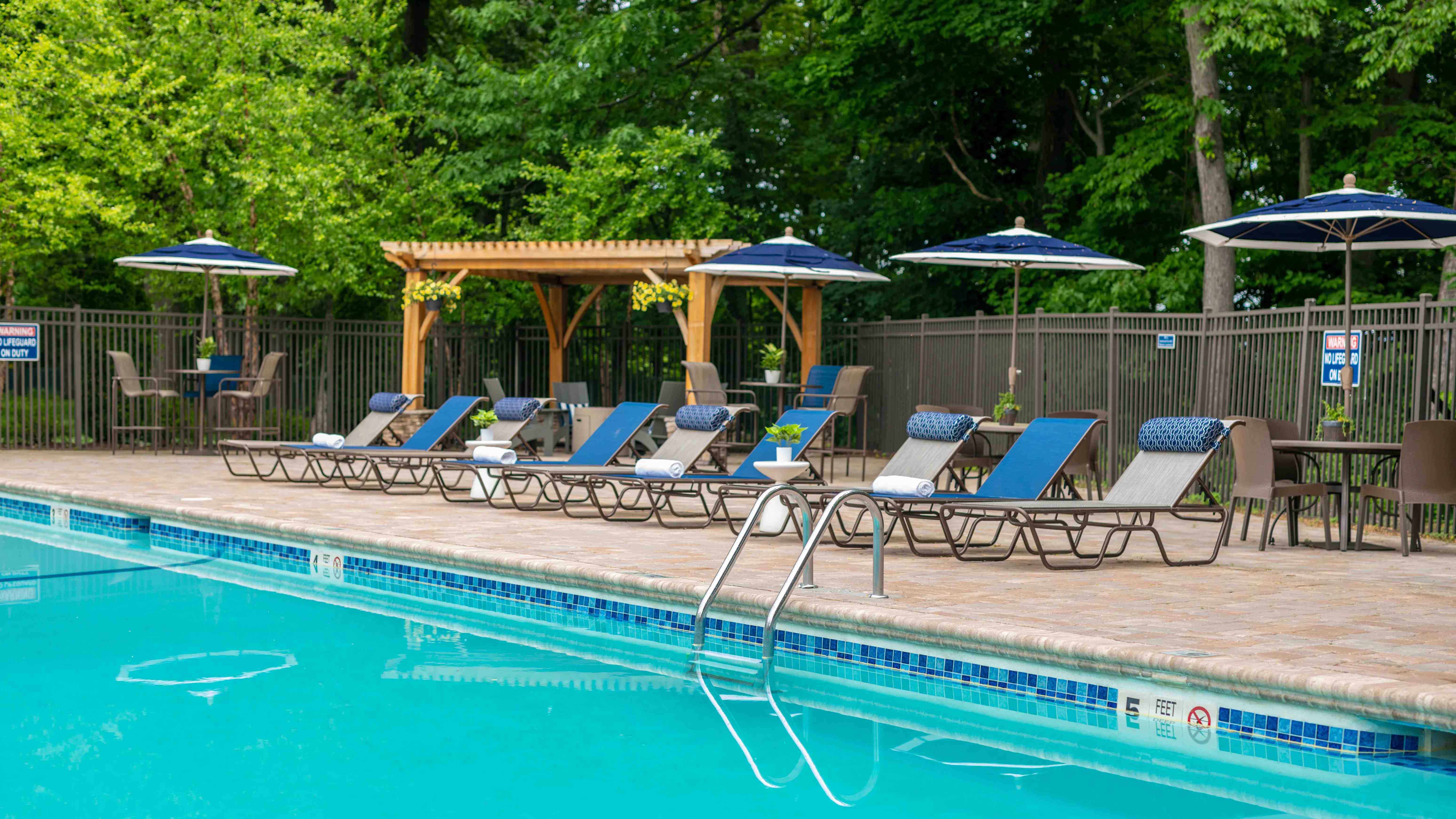 Step into our poolside paradise, where sun loungers, shaded tables, and a welcoming firepit create the ultimate gathering spot for friends and family.