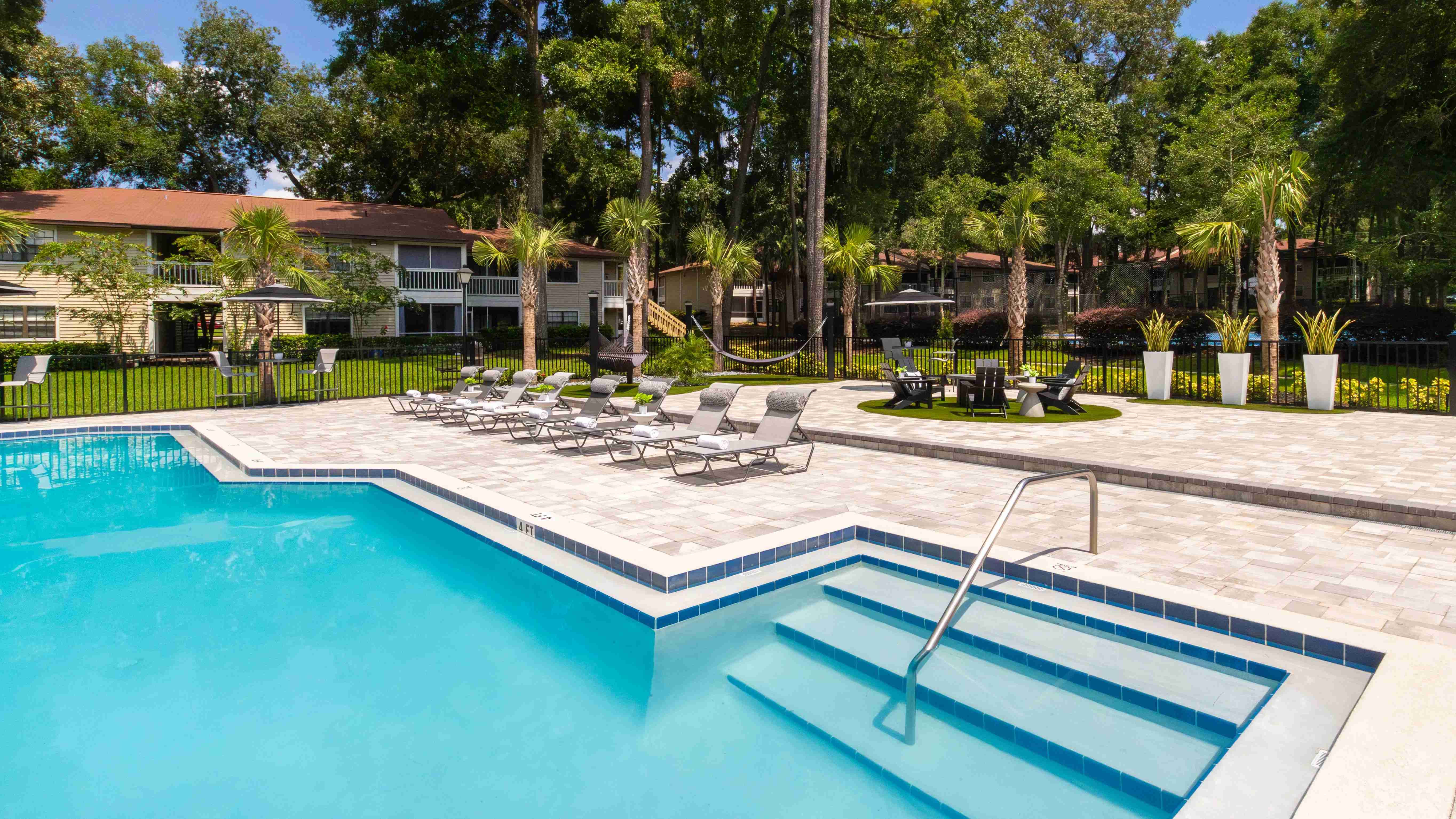Another angle of our spacious sundeck, showcasing a variety of seating options, from sun loungers to hammocks.