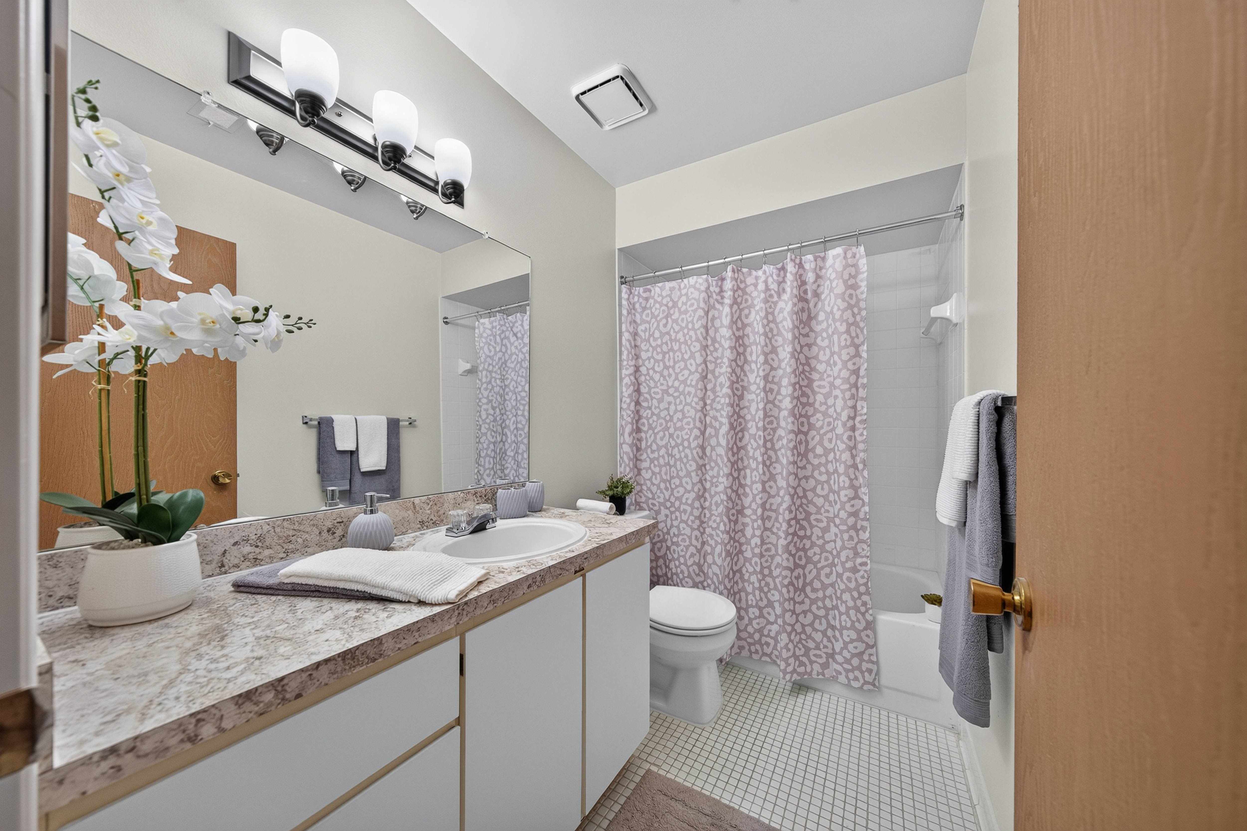 Spacious full bathroom at Eastwood Village Apartments in Clinton Township, MI.