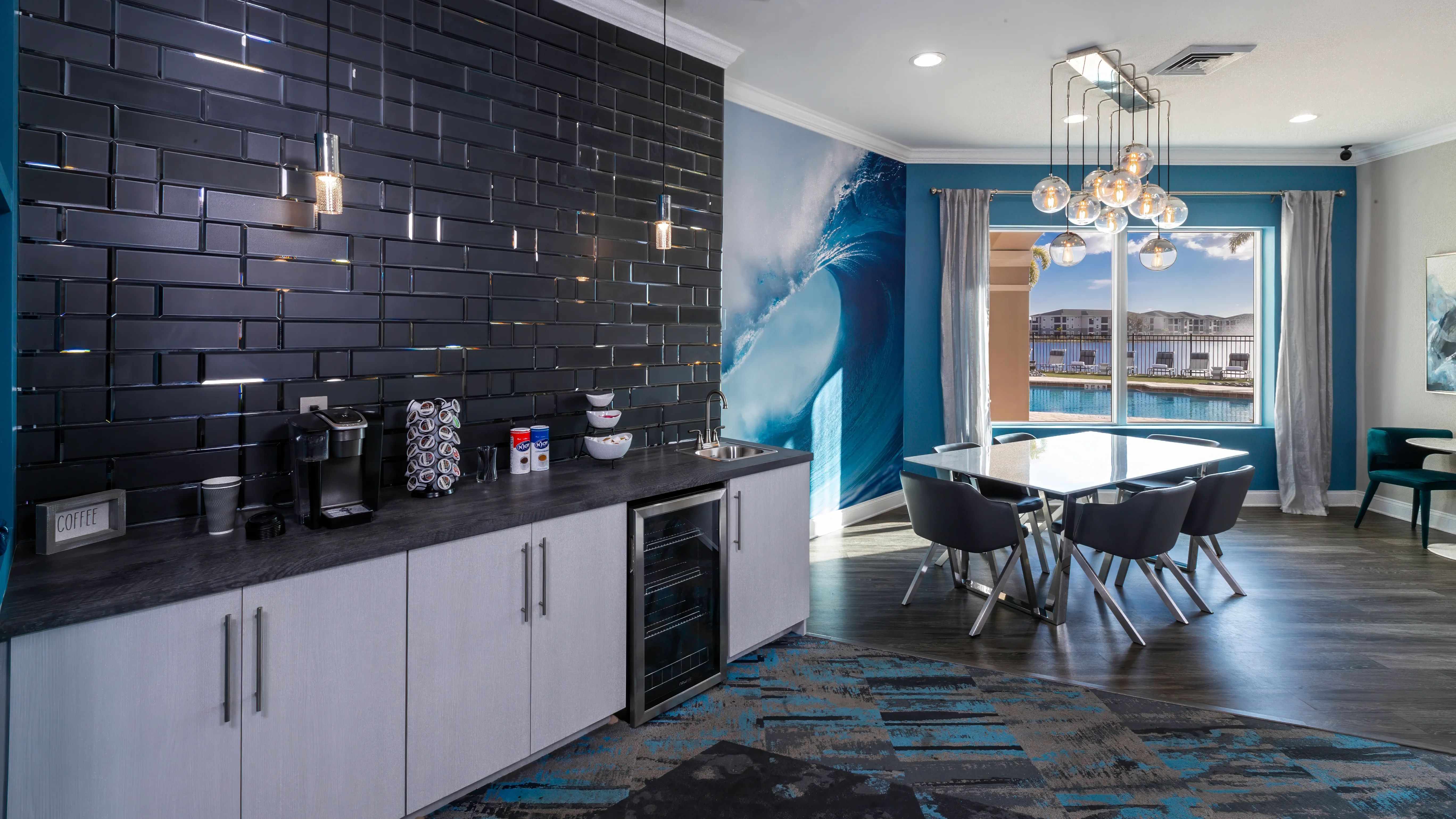 Enjoy complimentary coffee in the stylish clubhouse, complete with modern seating and a scenic lake view.