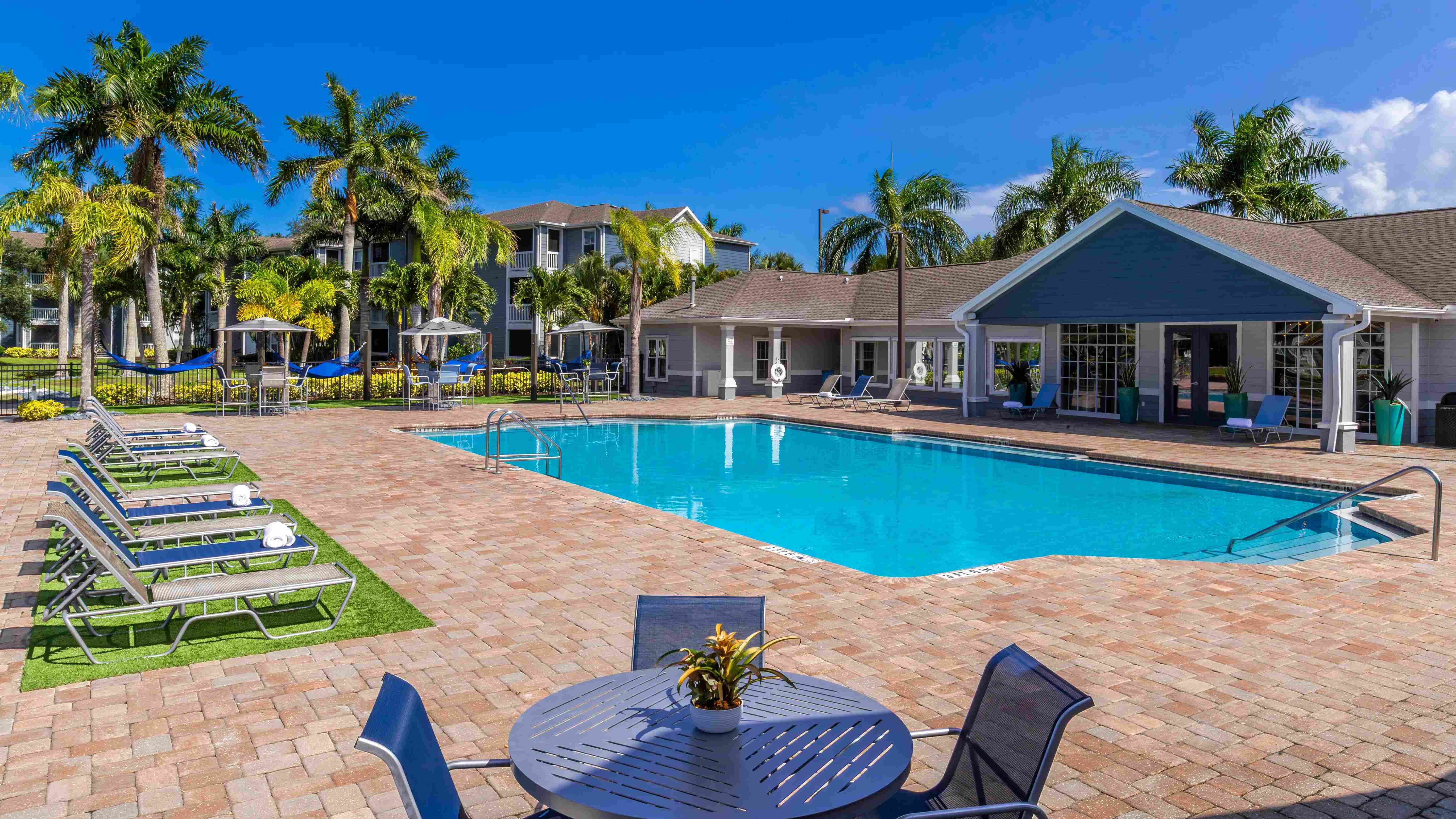 Lounge in style at our poolside retreat featuring plush sun loungers, shaded seating, and a sparkling pool just steps from your door.
