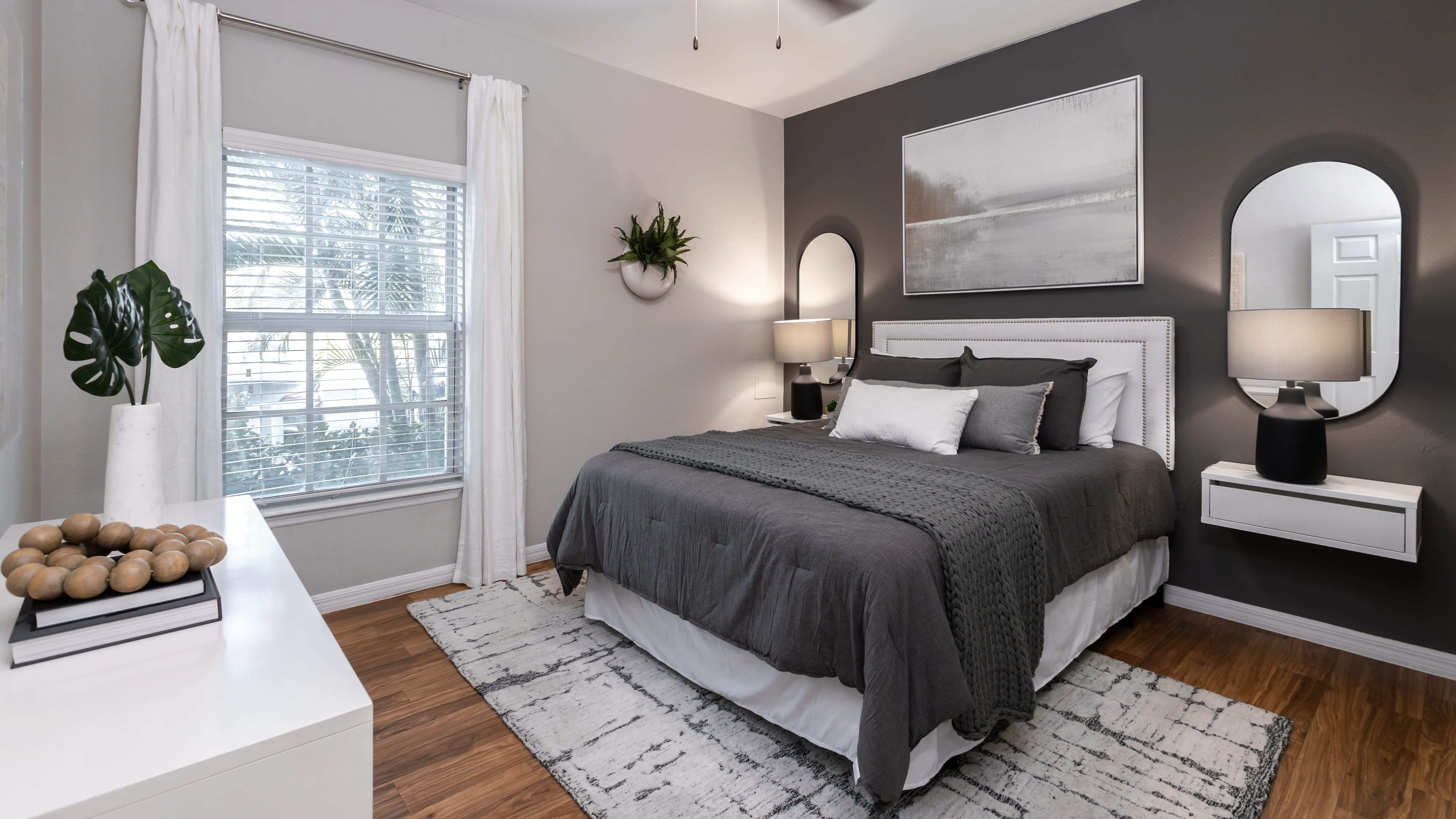 Unwind in this beautifully designed bedroom, featuring wood-style flooring, multi-speed ceiling fan, and a spacious closet.