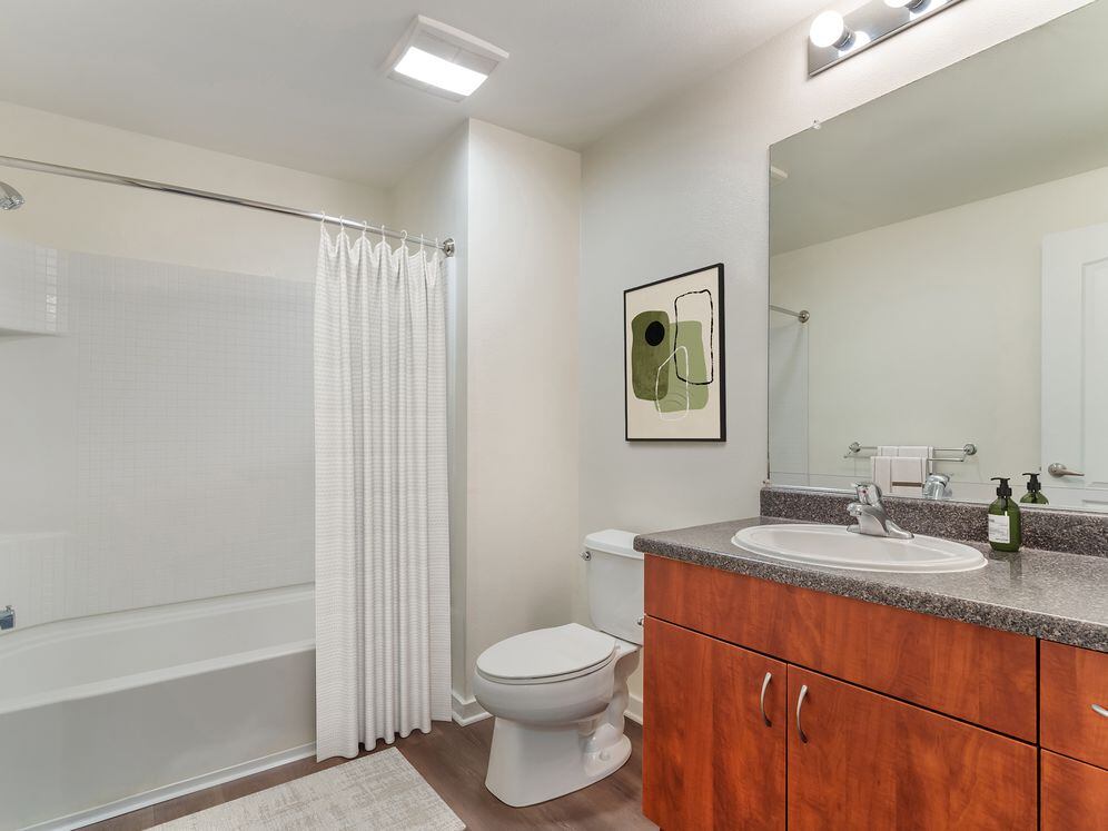 Classic Package II bath with grey laminate countertop, cherry cabinetry, and hard surface flooring